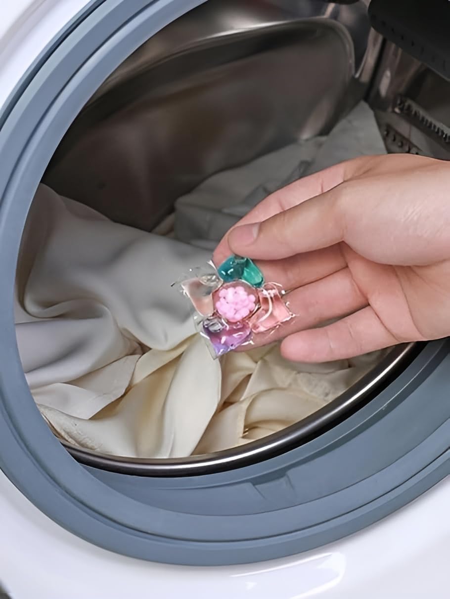 Putting laundry pod in washing machine drum